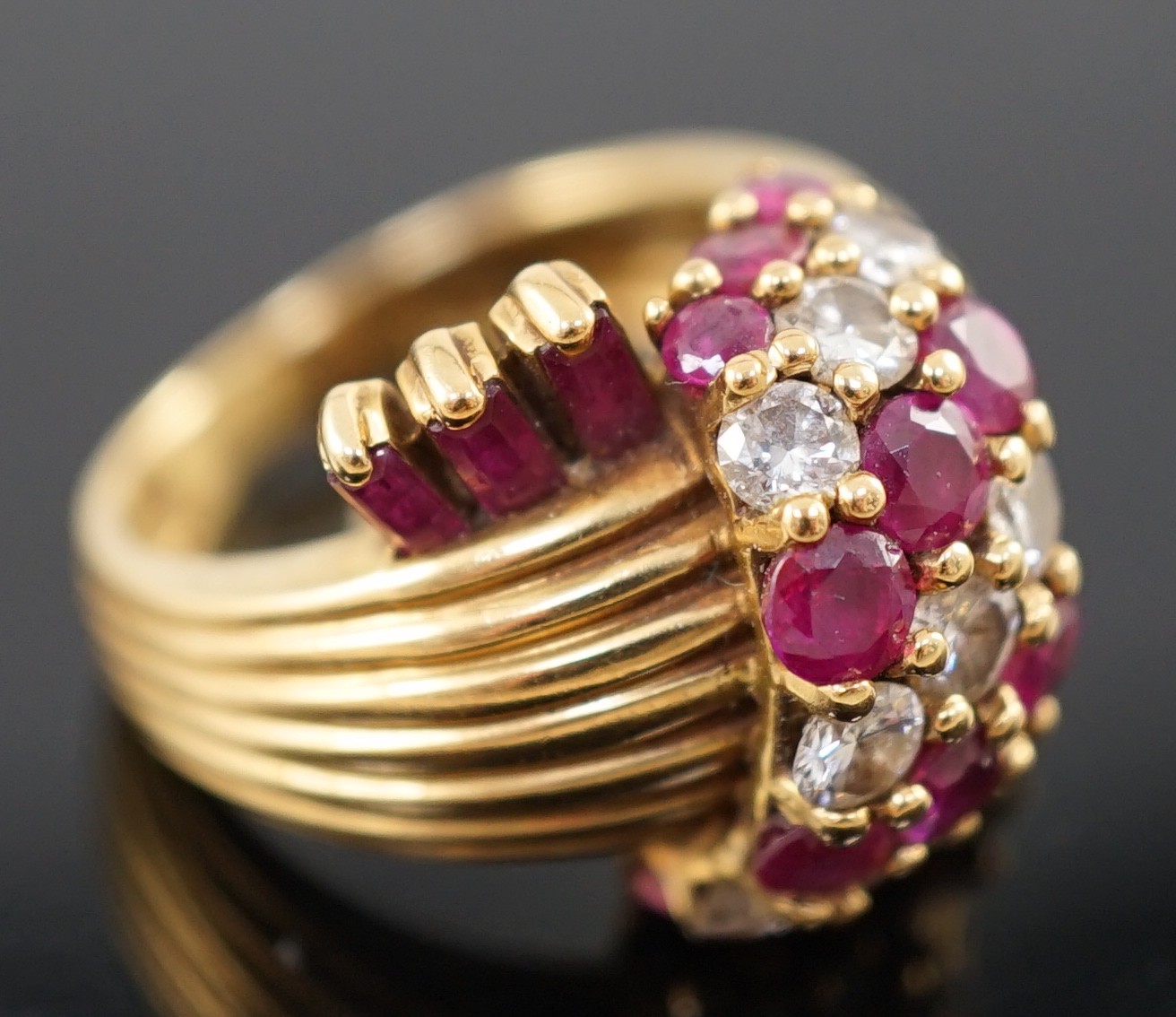 An early 1960's Kutchinsky 18ct gold ruby and diamond cluster set dress ring